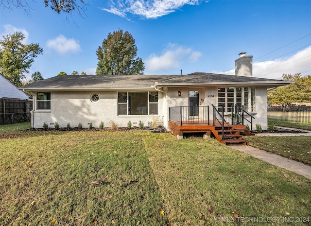 view of front facade with a front yard and a deck