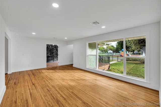 unfurnished room featuring light wood-style floors, recessed lighting, visible vents, and baseboards