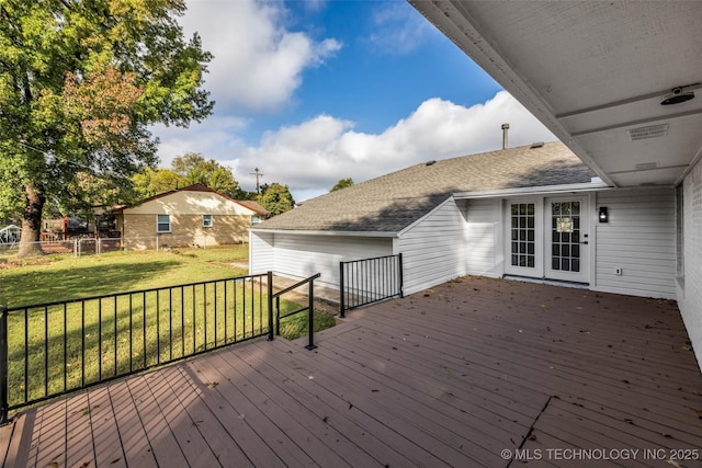 wooden deck featuring a lawn and fence