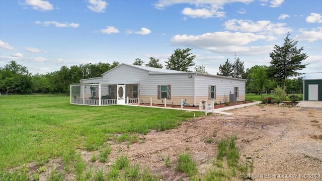 rear view of property featuring a lawn