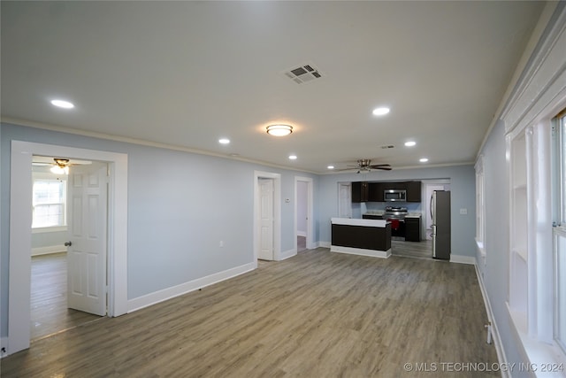 kitchen featuring ornamental molding, appliances with stainless steel finishes, wood-type flooring, and ceiling fan