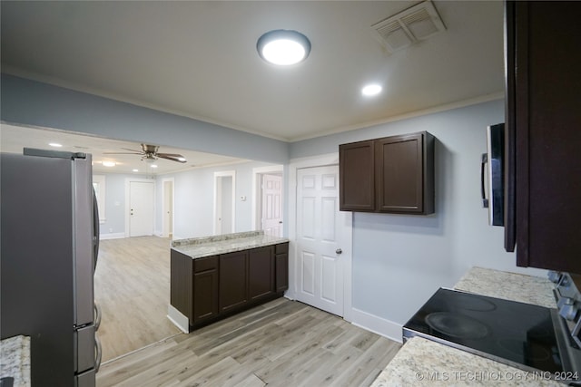 kitchen with dark brown cabinets, stainless steel appliances, and light hardwood / wood-style flooring