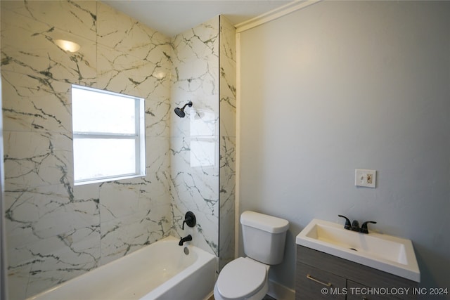 full bathroom with vanity, toilet, and tiled shower / bath combo