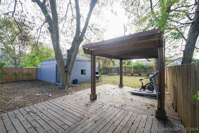 wooden deck with a yard and a storage unit