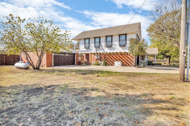 view of front of house with a garage and a front yard