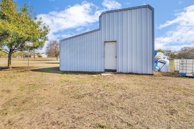 view of outbuilding with a lawn