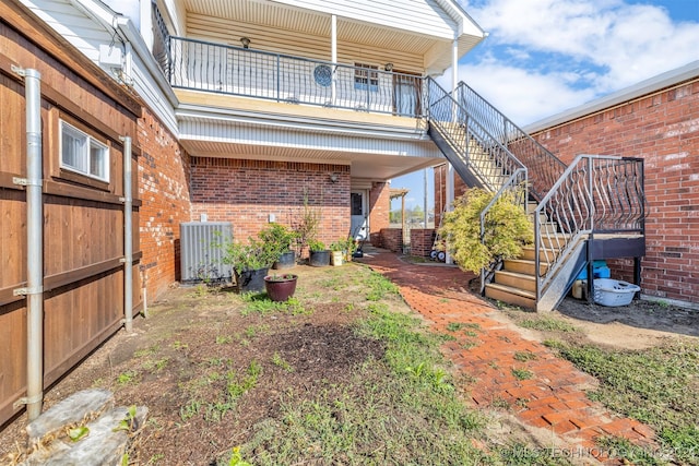 view of yard with a balcony and central AC