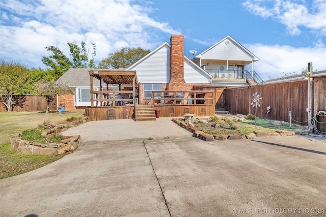 rear view of property featuring a balcony