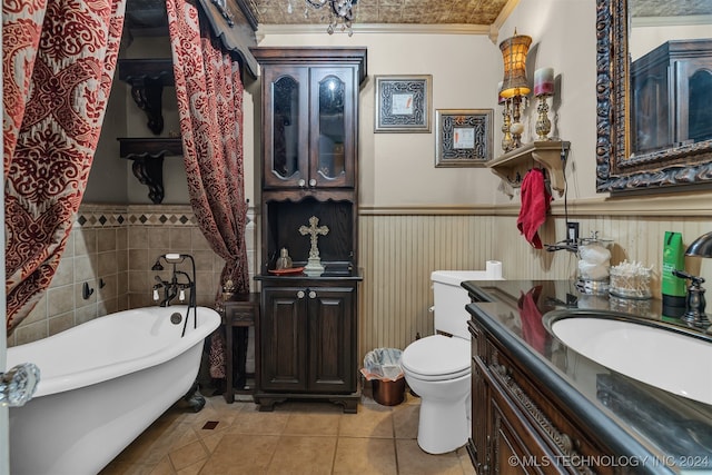 bathroom featuring ornamental molding, vanity, tile patterned floors, toilet, and a washtub