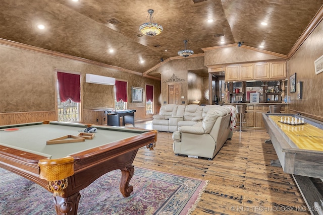 playroom with light wood-type flooring, a wall unit AC, vaulted ceiling, and ornamental molding