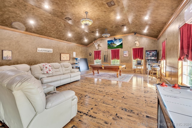 living room featuring hardwood / wood-style flooring, pool table, ornamental molding, a wall mounted AC, and vaulted ceiling