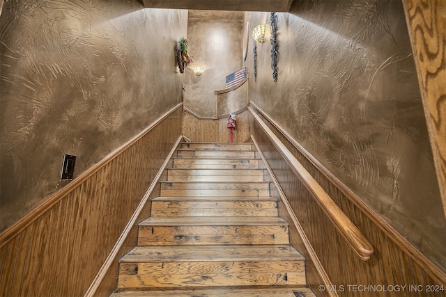 staircase with wooden walls