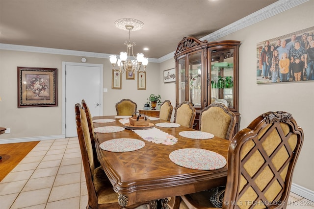 dining area with ornamental molding, a notable chandelier, and light tile patterned floors