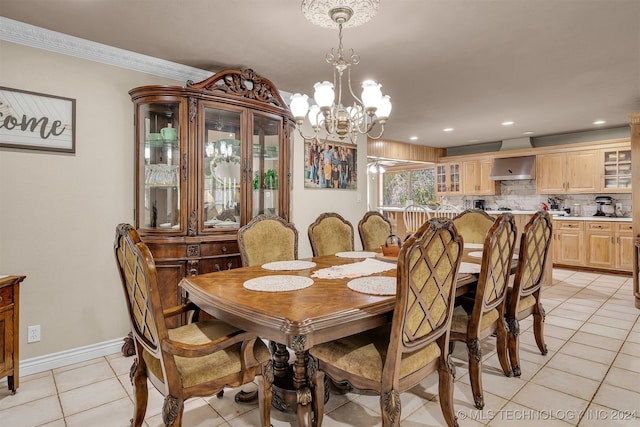 tiled dining space with a notable chandelier and ornamental molding