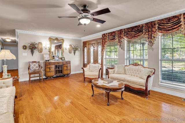 living room featuring ornamental molding, hardwood / wood-style floors, a healthy amount of sunlight, and ceiling fan