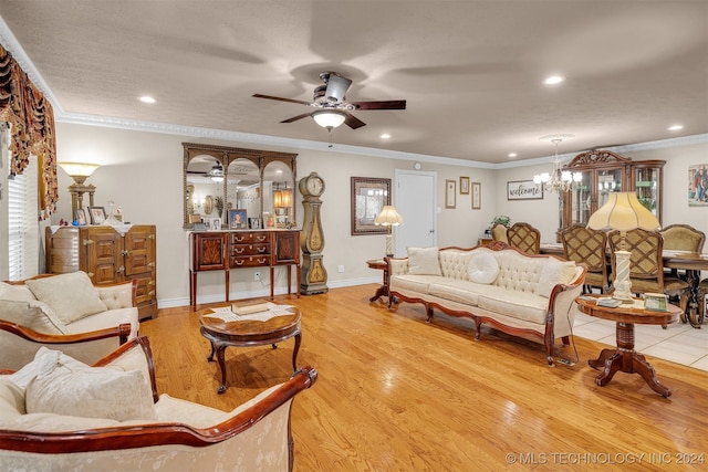 living room with a textured ceiling, ceiling fan with notable chandelier, ornamental molding, and light hardwood / wood-style flooring