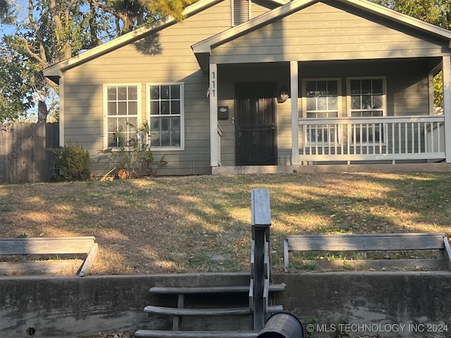 bungalow-style house with a front lawn and a porch