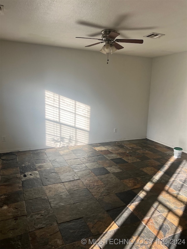 unfurnished room featuring ceiling fan