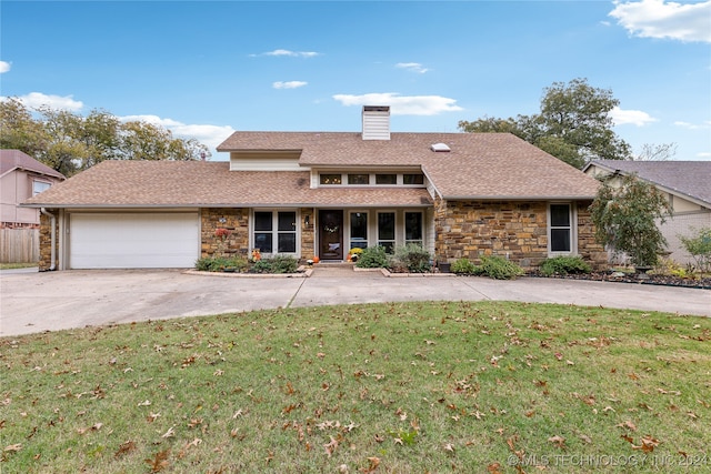 front of property with a garage and a front yard