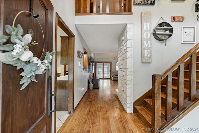 entrance foyer featuring light wood-type flooring and decorative columns