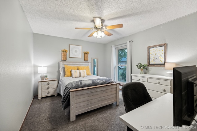 carpeted bedroom featuring a textured ceiling and ceiling fan