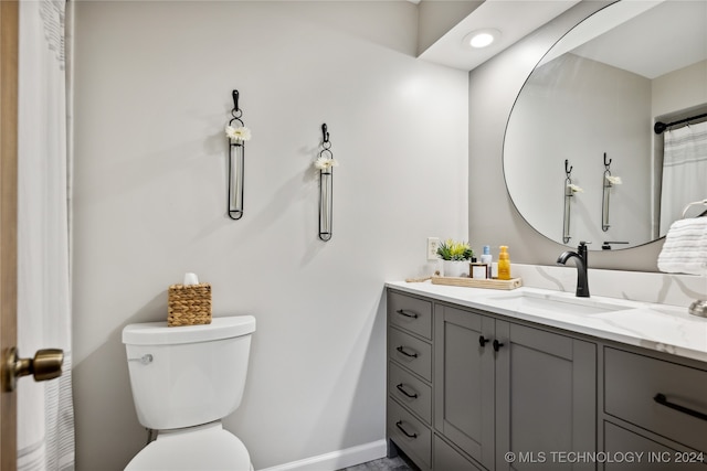 bathroom with toilet and vanity