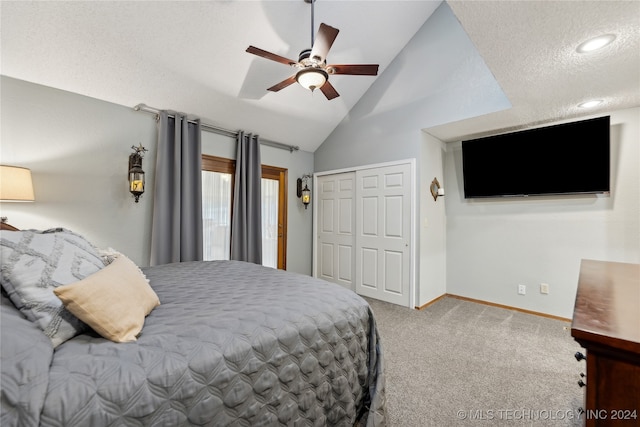 carpeted bedroom with high vaulted ceiling, a closet, a textured ceiling, and ceiling fan