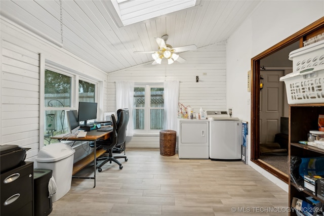 home office featuring light hardwood / wood-style floors, wood ceiling, wooden walls, washer and clothes dryer, and lofted ceiling with skylight