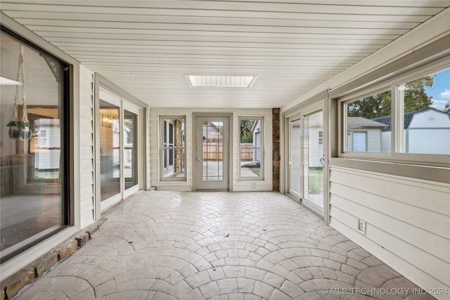 unfurnished sunroom with a wealth of natural light