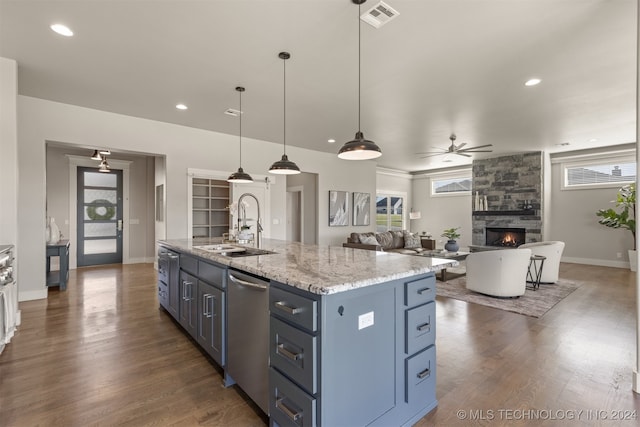 kitchen featuring decorative light fixtures, a kitchen island with sink, a healthy amount of sunlight, and ceiling fan