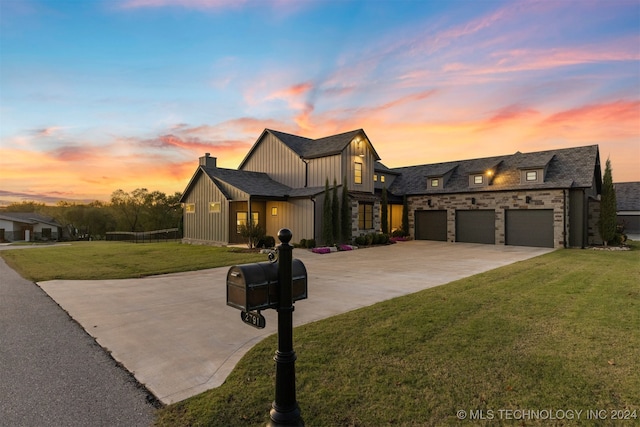 view of front of home with a garage and a yard