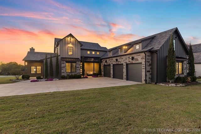 modern farmhouse style home with a lawn and a garage