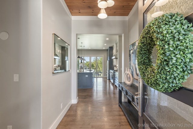 hallway featuring dark hardwood / wood-style flooring, crown molding, and wooden ceiling