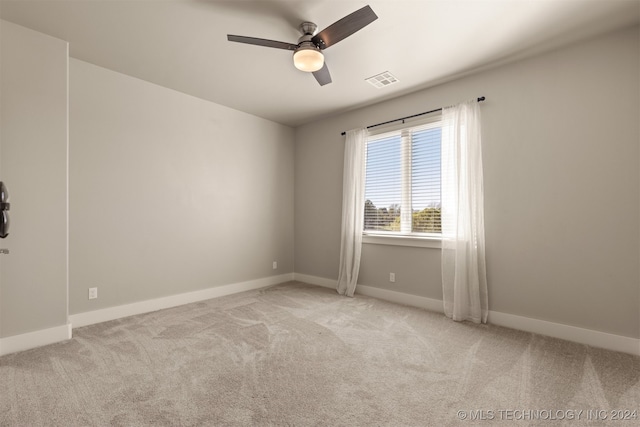 empty room featuring light carpet and ceiling fan