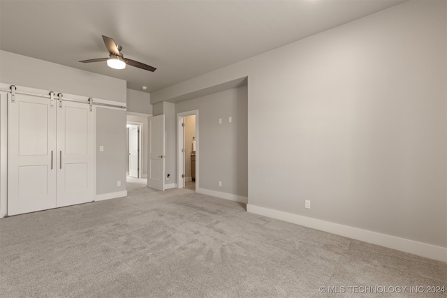 unfurnished bedroom with light carpet and ceiling fan