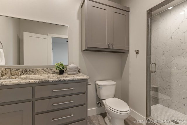 bathroom featuring vanity, toilet, and walk in shower