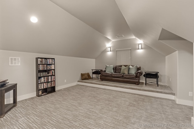 interior space featuring light colored carpet and vaulted ceiling