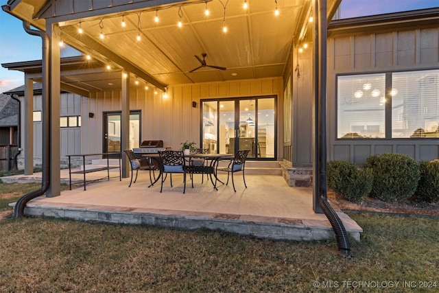 patio terrace at dusk featuring ceiling fan