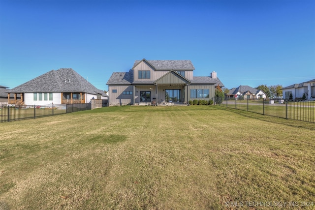 rear view of house with a yard