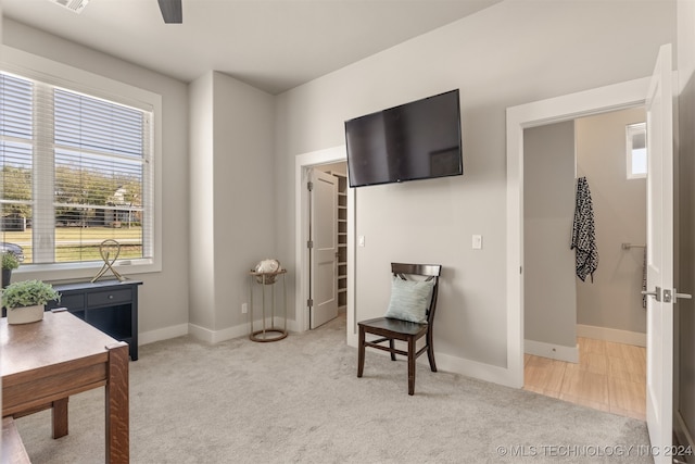 home office featuring ceiling fan and light colored carpet