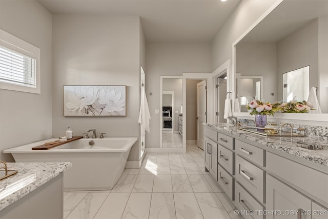 bathroom with a tub to relax in and vanity