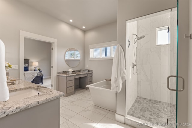 bathroom with vanity, plenty of natural light, and independent shower and bath