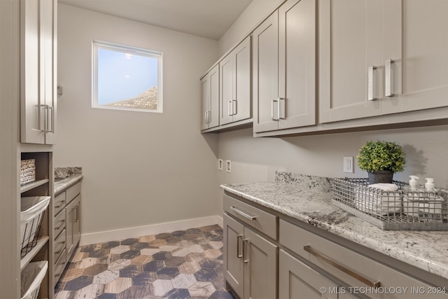 clothes washing area featuring cabinets and hookup for a washing machine