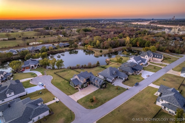 aerial view at dusk with a water view