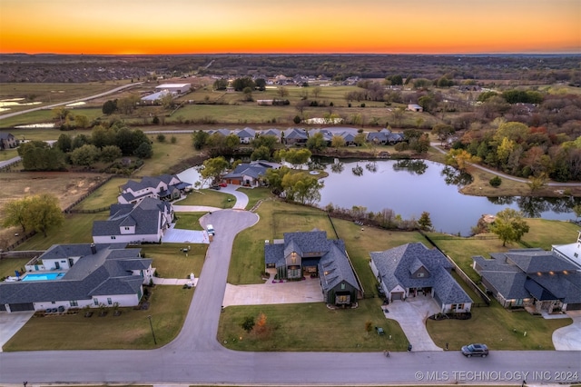 aerial view at dusk with a water view