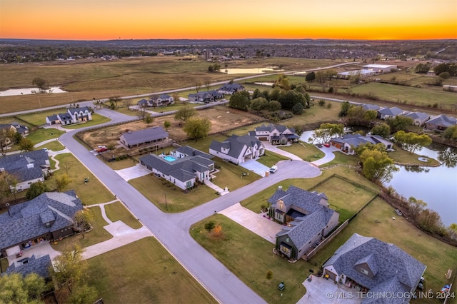 aerial view at dusk with a water view