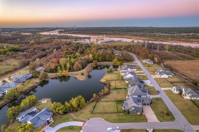 aerial view at dusk with a water view