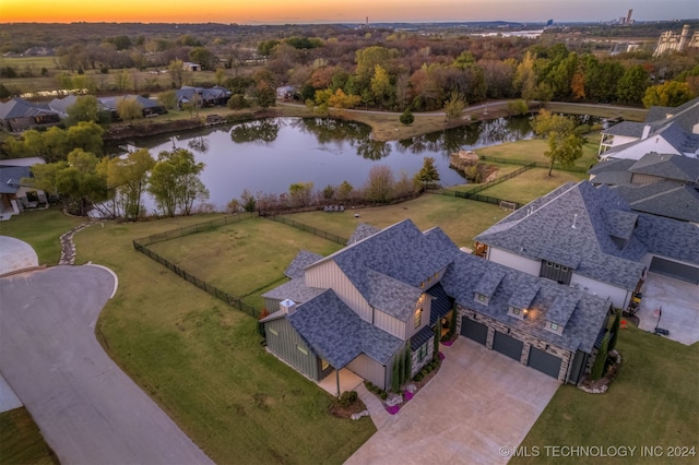 aerial view at dusk with a water view