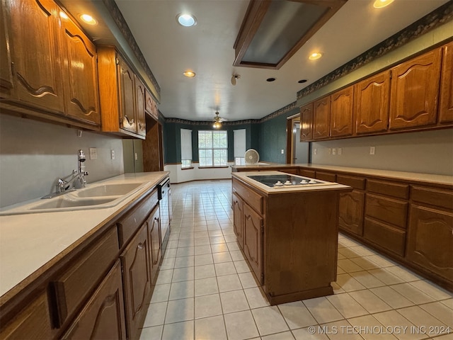 kitchen featuring sink, ceiling fan, light tile patterned floors, a center island, and dishwasher