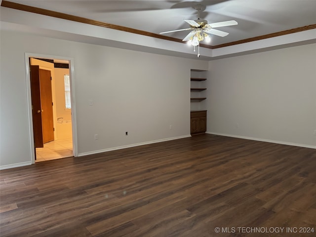 unfurnished room featuring ceiling fan, dark hardwood / wood-style floors, and crown molding